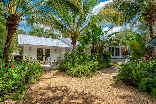 rear view of property featuring a patio and french doors