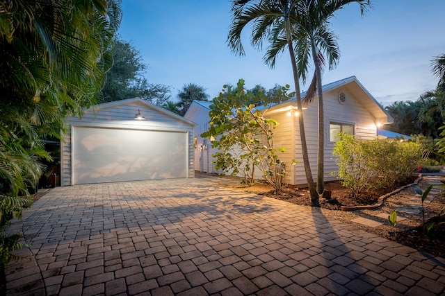 view of garage at dusk