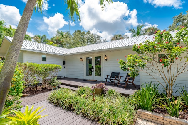 back of property featuring french doors and a wooden deck