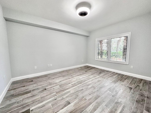 spare room with hardwood / wood-style flooring