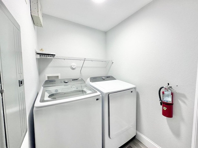 clothes washing area with separate washer and dryer