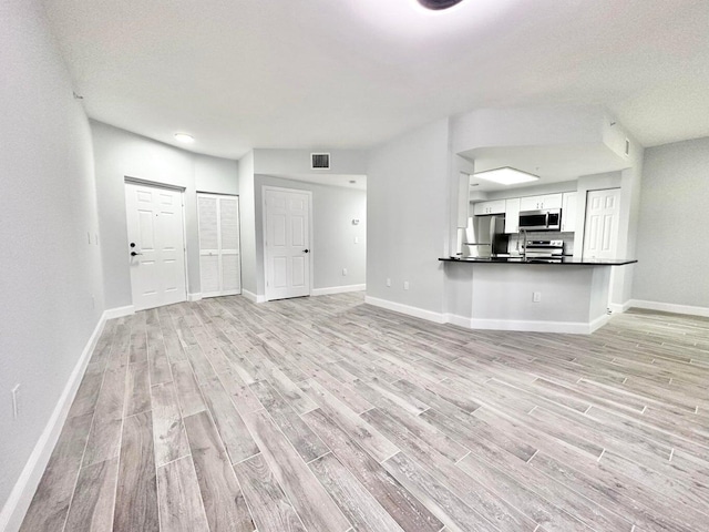 unfurnished living room with light wood-type flooring