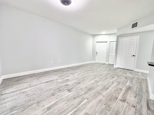 unfurnished room with light hardwood / wood-style flooring