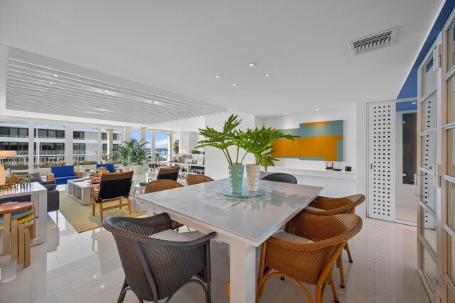 tiled dining area featuring expansive windows