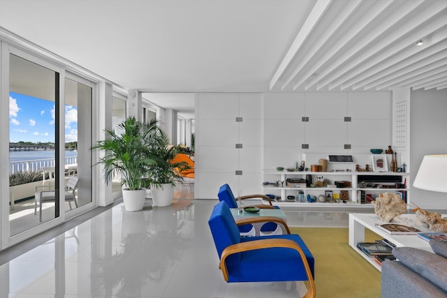 recreation room featuring expansive windows and a water view