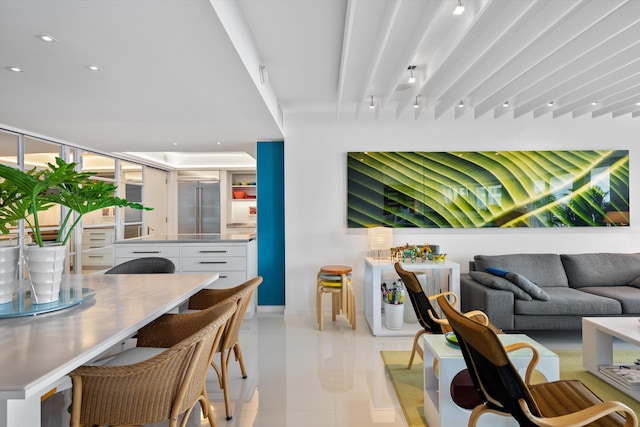 interior space featuring baseboards, light tile patterned flooring, and recessed lighting