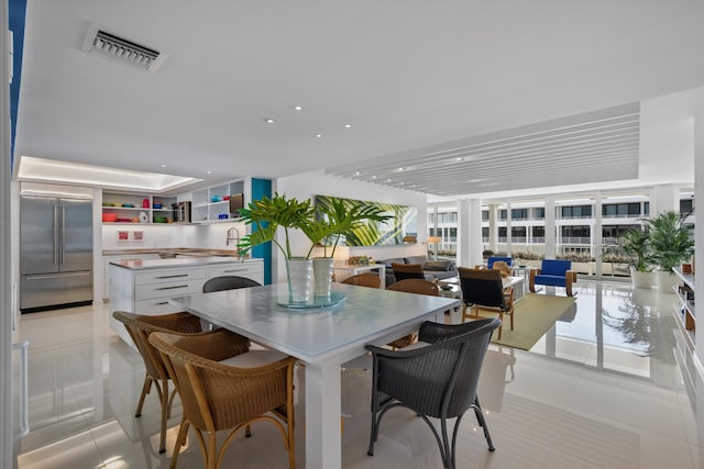 dining area with light tile patterned flooring and sink