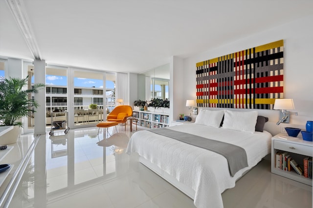 bedroom with expansive windows and tile patterned flooring