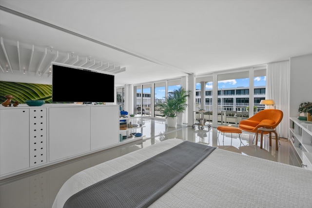 bedroom featuring a wall of windows and hardwood / wood-style floors