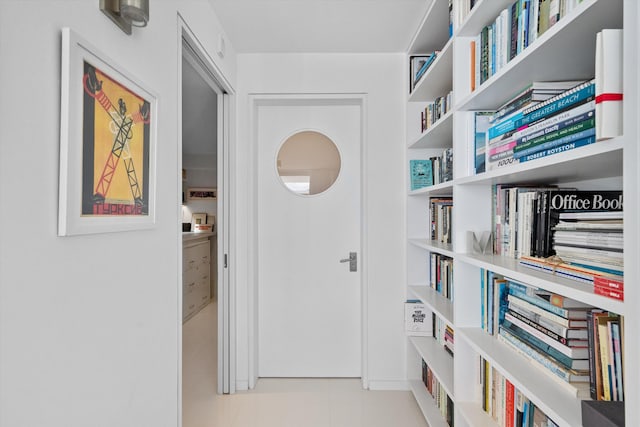 hall featuring light tile patterned floors