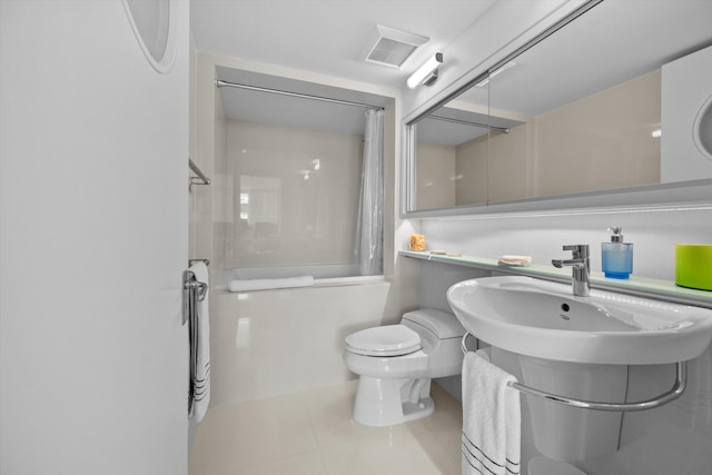 full bath with tile patterned floors, a sink, toilet, visible vents, and shower / tub combo