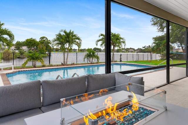 view of swimming pool with a fenced in pool, a fenced backyard, a water view, and a fire pit