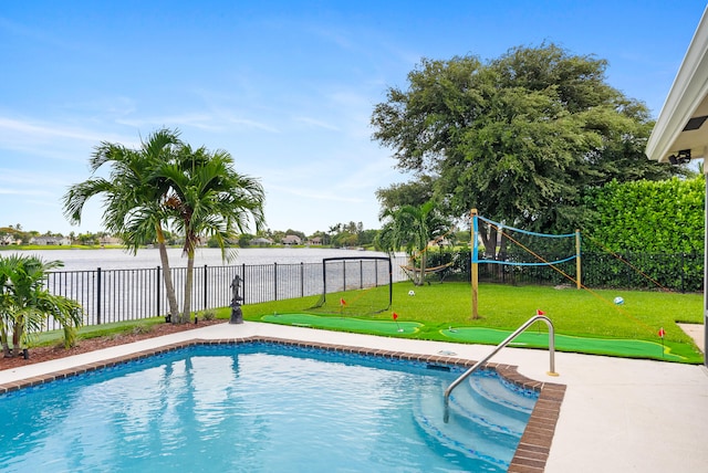 view of swimming pool featuring a water view and a lawn