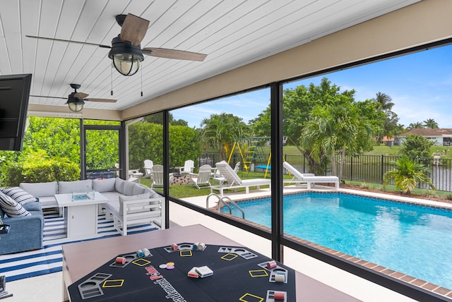 view of swimming pool featuring outdoor lounge area, a patio area, and ceiling fan