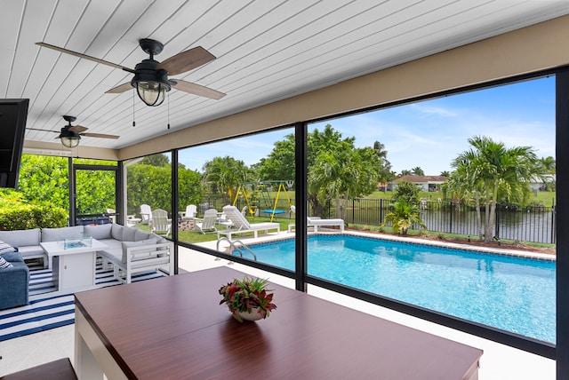 view of pool featuring a water view and ceiling fan