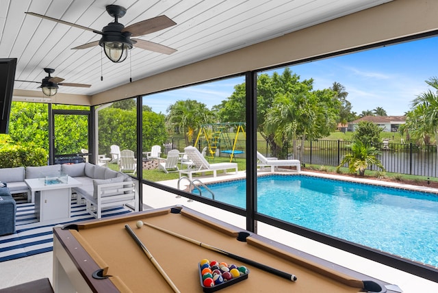 view of pool with outdoor lounge area and ceiling fan