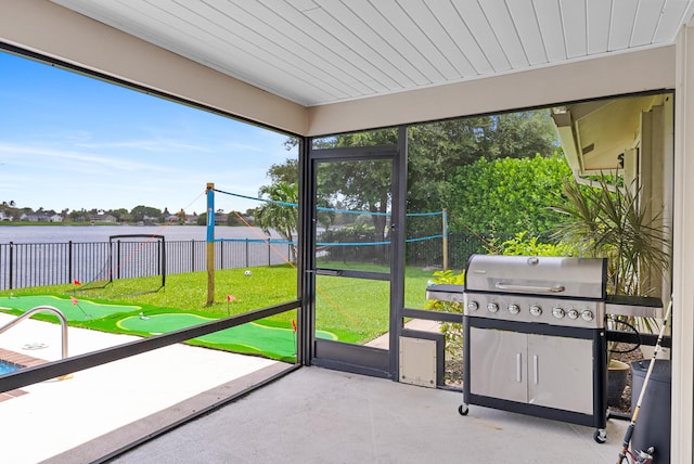 unfurnished sunroom with a water view