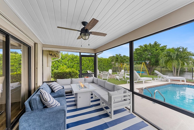 sunroom featuring ceiling fan and wood ceiling