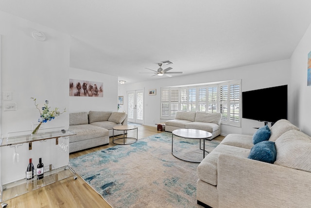 living room featuring ceiling fan and hardwood / wood-style flooring