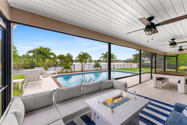 view of pool with a patio area, a fenced backyard, a fenced in pool, and an outdoor living space with a fire pit