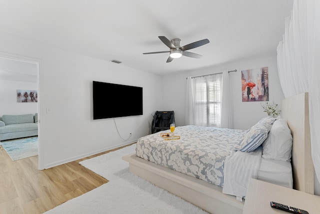 bedroom featuring hardwood / wood-style flooring and ceiling fan