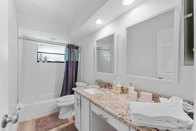 full bathroom with vanity, shower / tub combo with curtain, and toilet