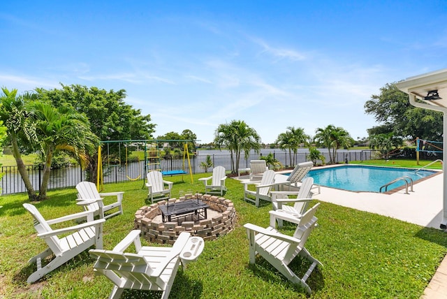 view of pool featuring a fire pit, a lawn, a water view, and a patio area