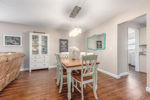 dining room featuring an inviting chandelier and dark hardwood / wood-style floors