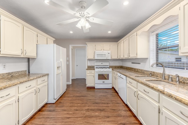 kitchen with white cabinets, sink, dark hardwood / wood-style flooring, and white appliances