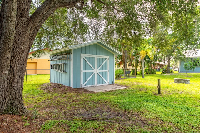 view of outbuilding featuring a yard