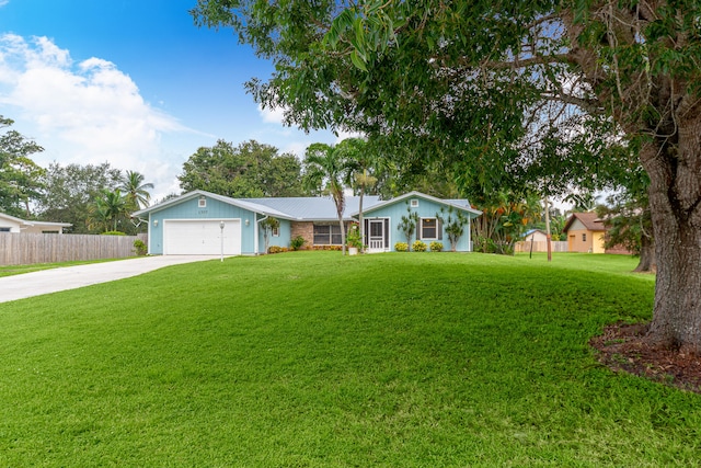 ranch-style house featuring a front yard and a garage