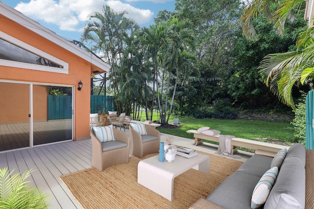 wooden terrace featuring outdoor lounge area and a lawn