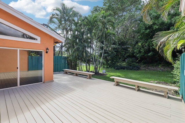 wooden deck featuring a lawn