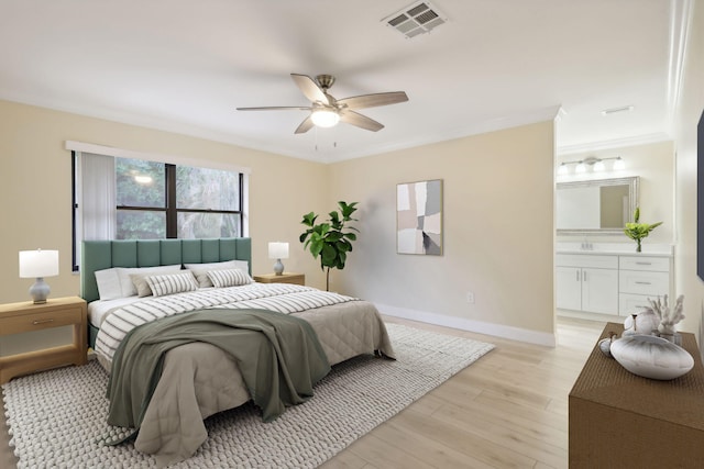 bedroom featuring ceiling fan, ensuite bathroom, light hardwood / wood-style floors, crown molding, and sink