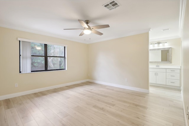 empty room featuring sink, crown molding, light hardwood / wood-style floors, and ceiling fan