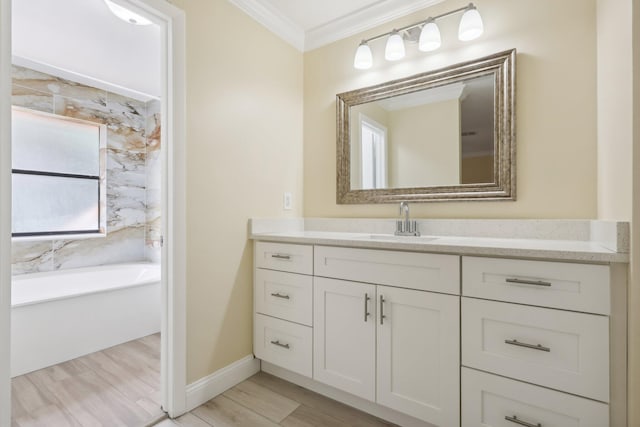 bathroom featuring vanity, a tub, and ornamental molding