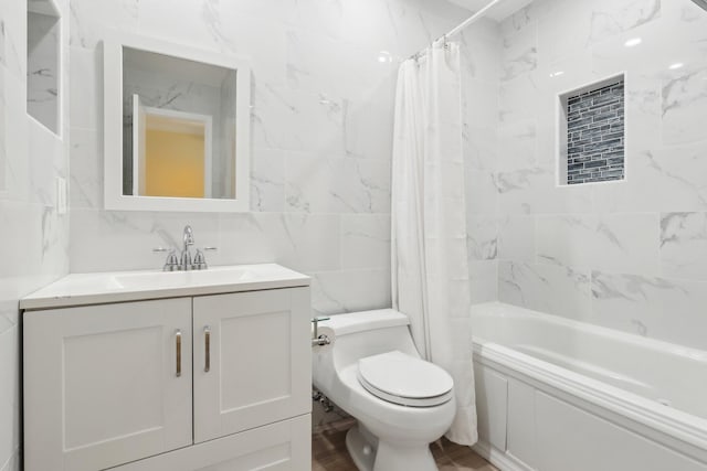 full bathroom with decorative backsplash, shower / tub combo, tile walls, toilet, and vanity