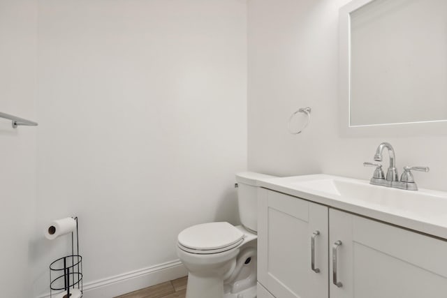 bathroom featuring vanity, toilet, and wood-type flooring