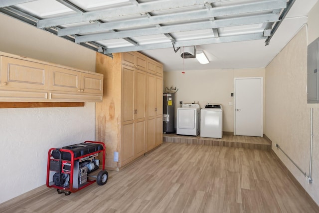 garage featuring water heater, independent washer and dryer, and a garage door opener