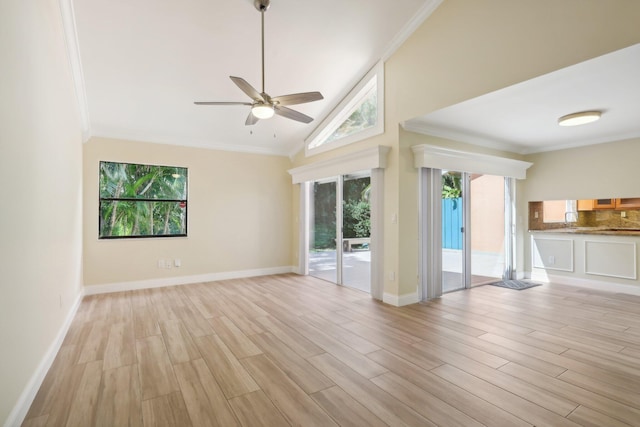 unfurnished living room featuring light hardwood / wood-style flooring, crown molding, and a wealth of natural light