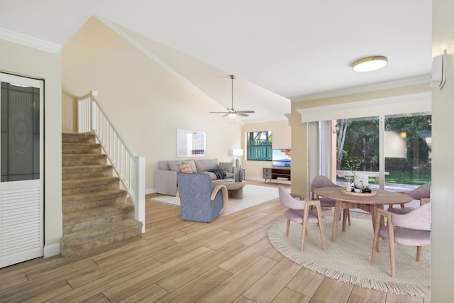 dining area with crown molding, high vaulted ceiling, light wood-type flooring, and ceiling fan