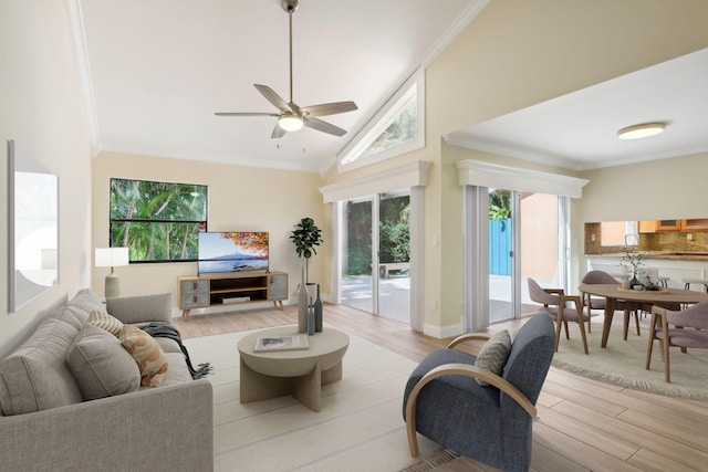 living room featuring crown molding, light hardwood / wood-style flooring, high vaulted ceiling, and ceiling fan