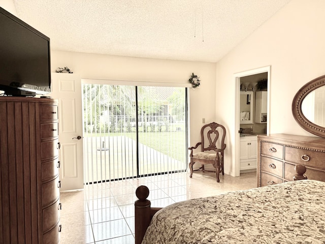 tiled bedroom featuring connected bathroom, vaulted ceiling, access to outside, and a textured ceiling