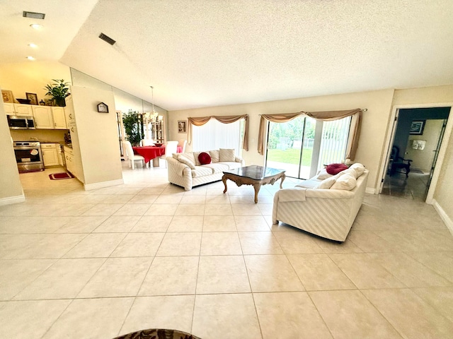 living room with lofted ceiling, a textured ceiling, and light tile patterned flooring