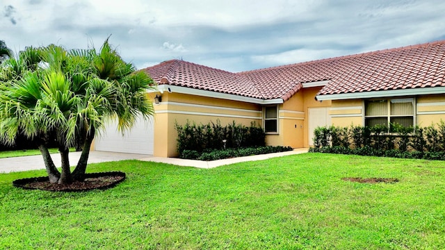 view of front of property featuring a front yard and a garage