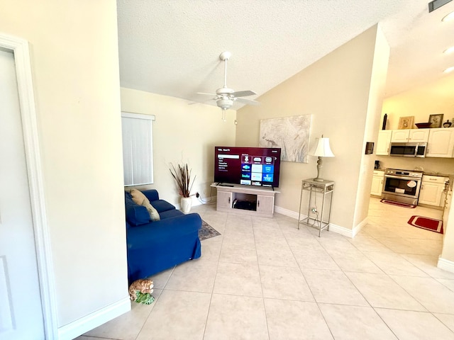 tiled living room featuring ceiling fan, a textured ceiling, and vaulted ceiling