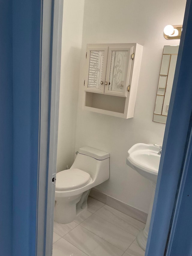 bathroom with tile patterned floors, sink, and toilet