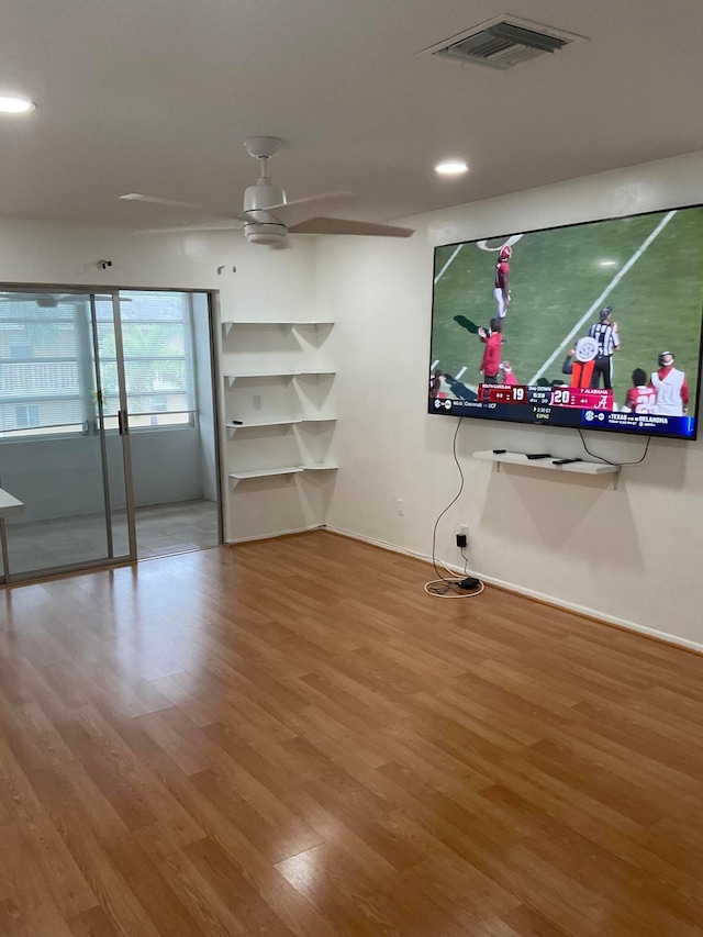 interior space featuring wood-type flooring and ceiling fan