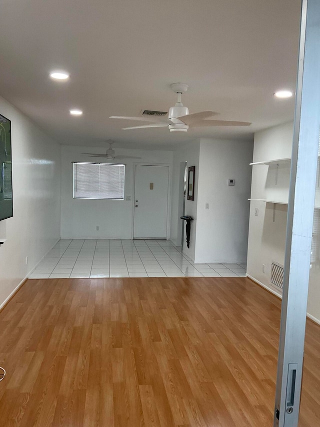 spare room featuring ceiling fan and light hardwood / wood-style floors