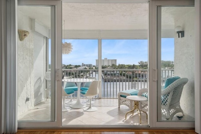 doorway to outside featuring hardwood / wood-style floors and a water view